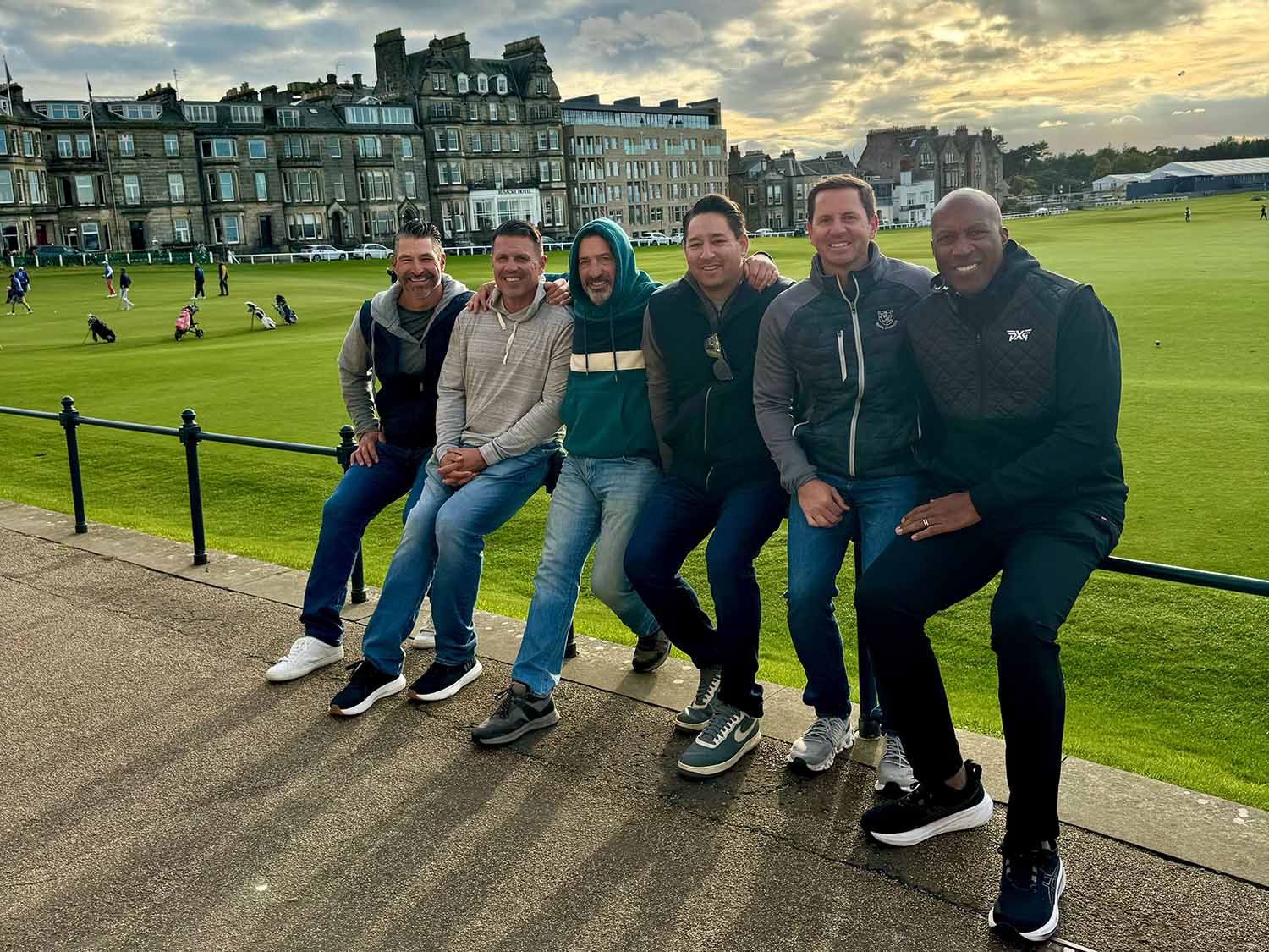 Golfers by 18th green of The Old Course, a top destination for golf travel companies.